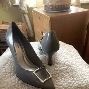 Woman’s grey 3 inch buckle heels
